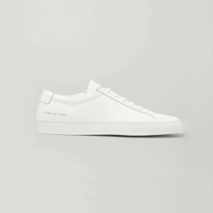 white low top leather sneakers side profile on a grey background