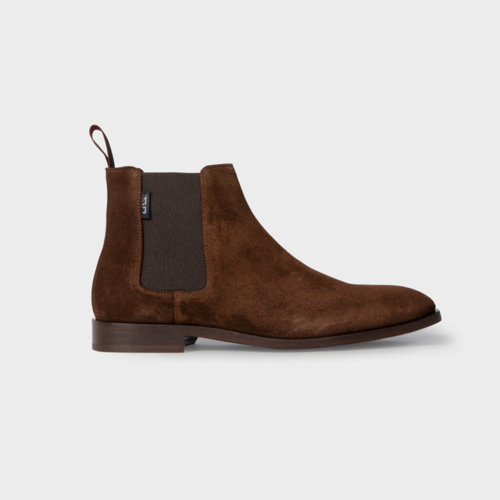Brown suede Chelsea boots side profile on a light grey solid background